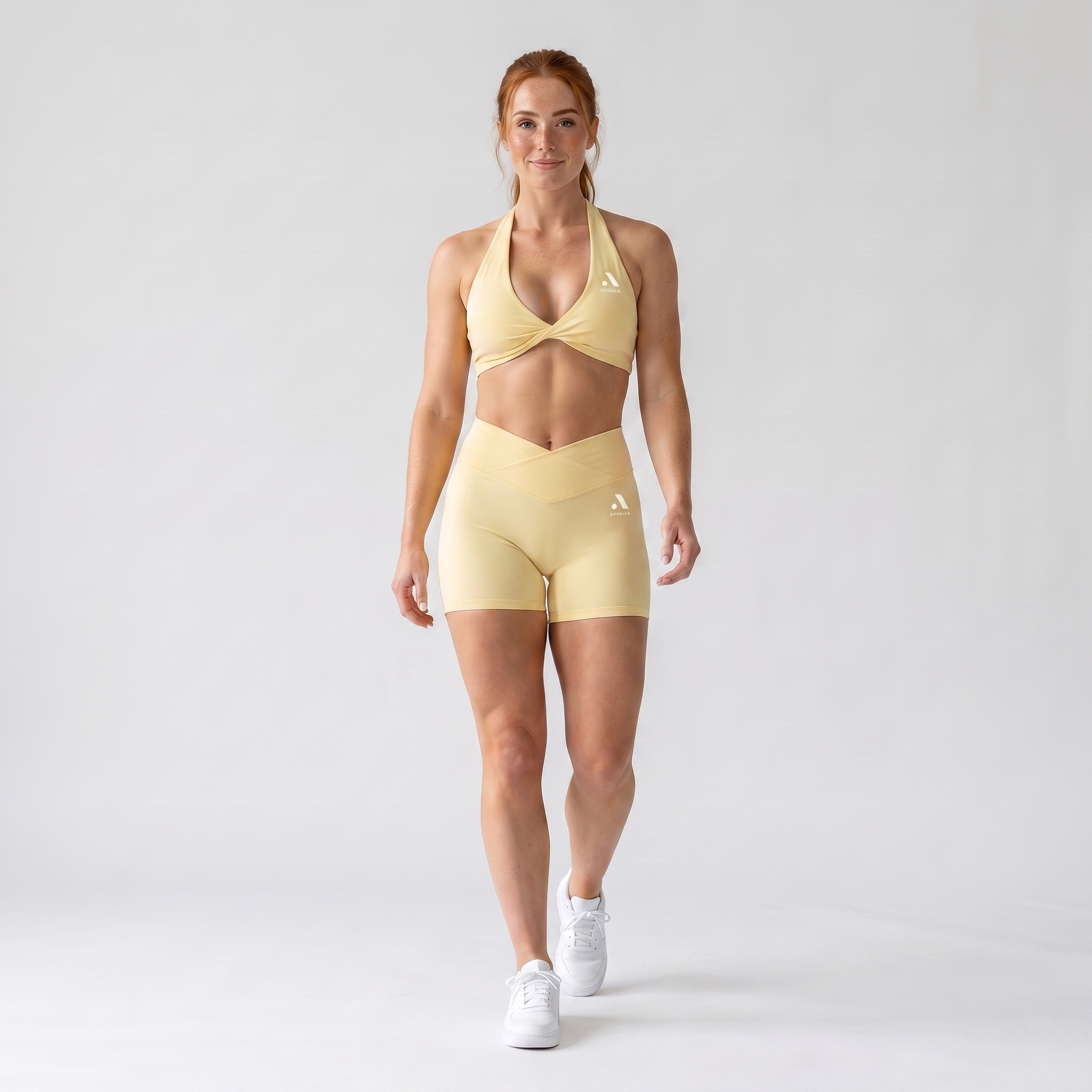 GYMELVA Twist Halter Short Set Butter Yellow - walking